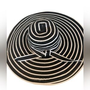 Chic oversized black and white striped sun hat with dramatic wide brim.